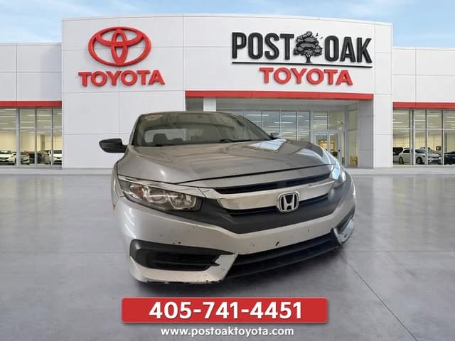 Post Oak Toyota source photo of a silver Honda Civic with dealership storefront branding, phone number and website text